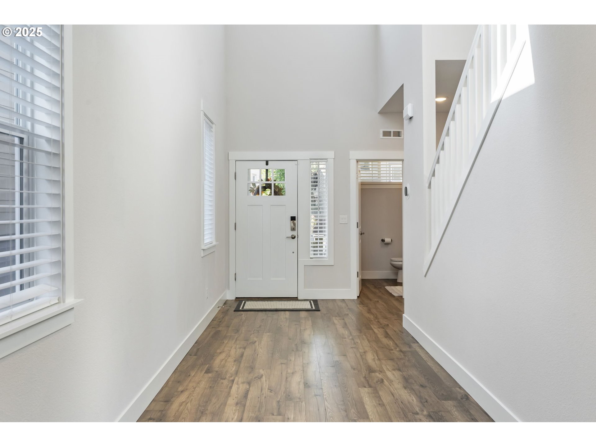 18246 Southwest Silvertip Street Beaverton, OR 97007 - Photo 3 of 46 a view of an empty room with wooden floor and a window