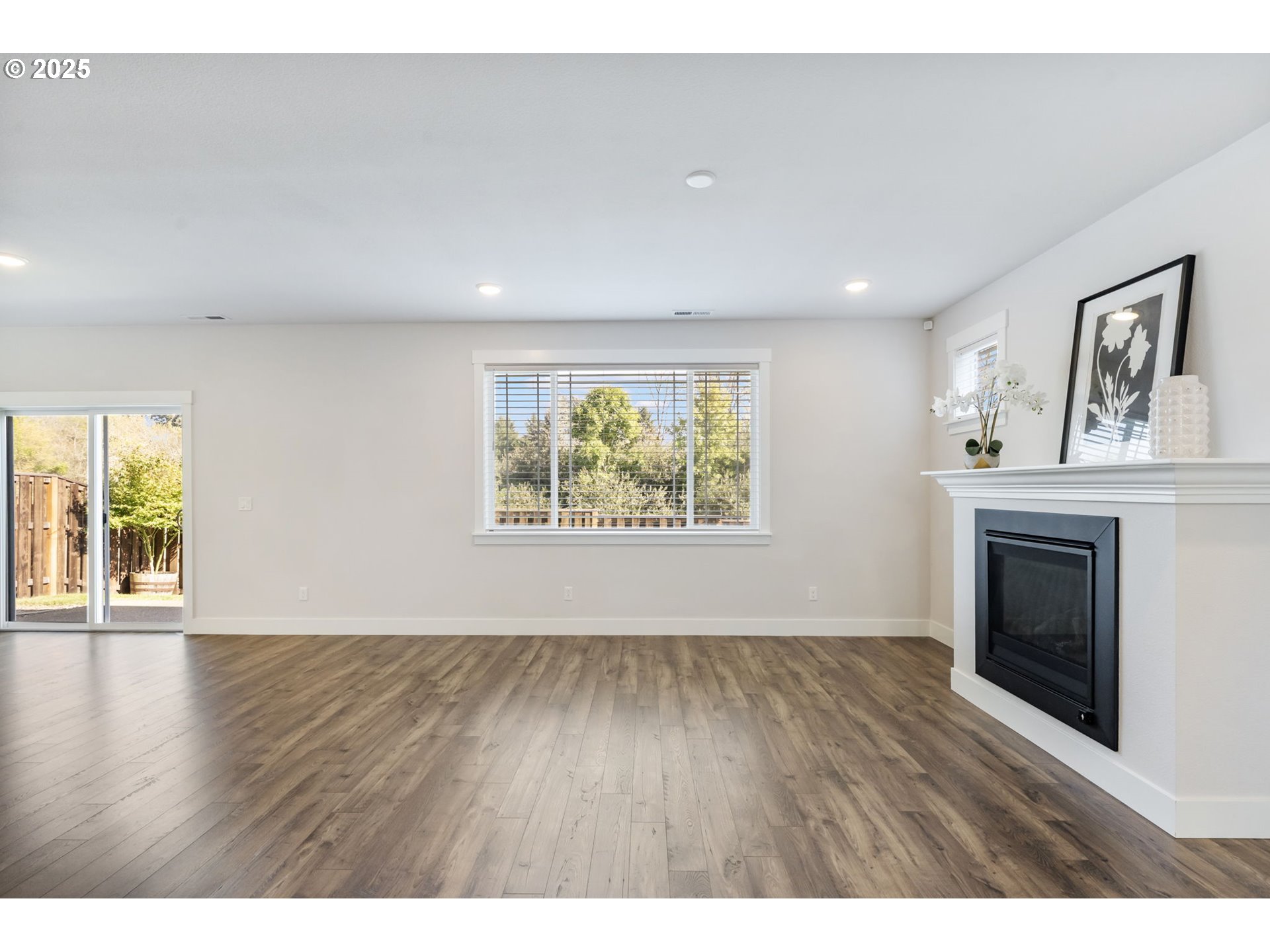 18246 Southwest Silvertip Street Beaverton, OR 97007 - Photo 4 of 46 a view of an empty room with a fireplace and a window