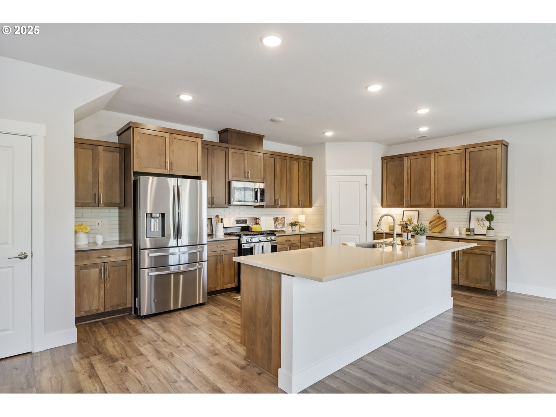 18246 Southwest Silvertip Street Beaverton, OR 97007 - Photo 7 of 46 a kitchen with refrigerator and cabinets