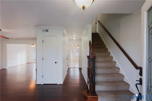 a view of an empty room with wooden floor