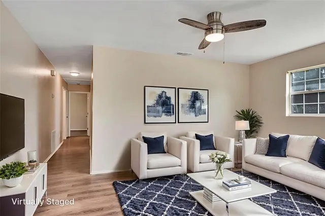 a living room with furniture and a flat screen tv