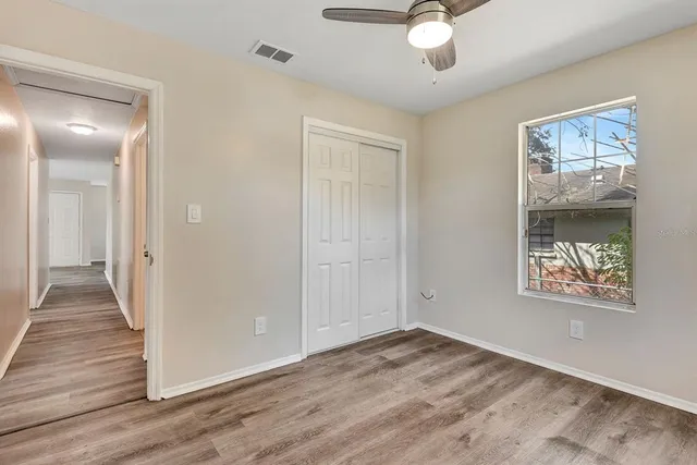 wooden floor in an empty room with a window