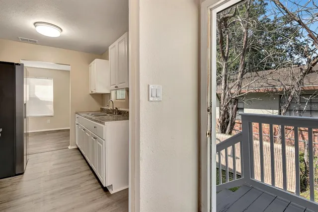 a kitchen with granite countertop a stove and a refrigerator
