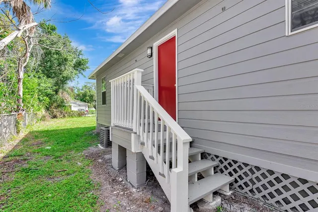 a view of a house with backyard and deck