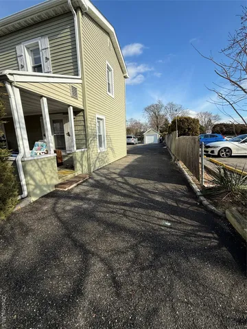 a view of a house with a car parked beside it
