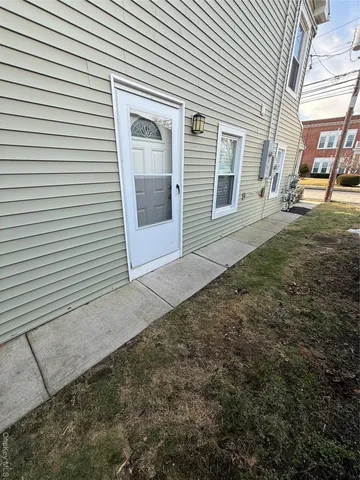 a view of a porch with a table and chairs and wooden fence