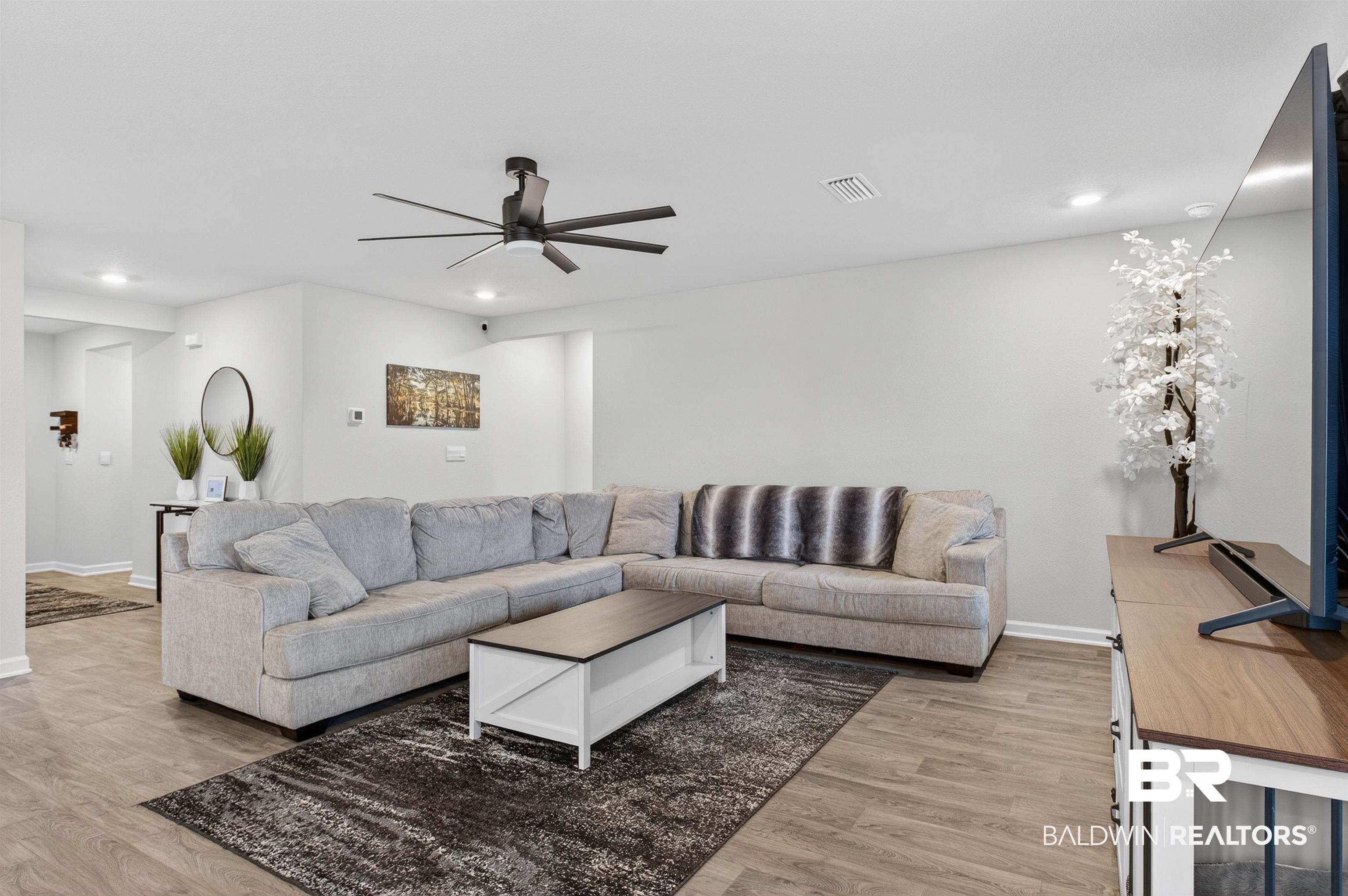 3213 Camino Real Loop Lillian, AL 36549 - Photo 23 of 61 Spacious living area featuring wood-finish flooring, recessed lighting, and a modern ceiling fan