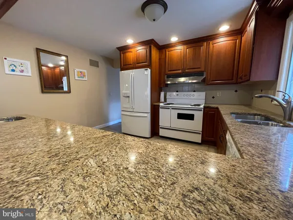 a living room with furniture and a lamp