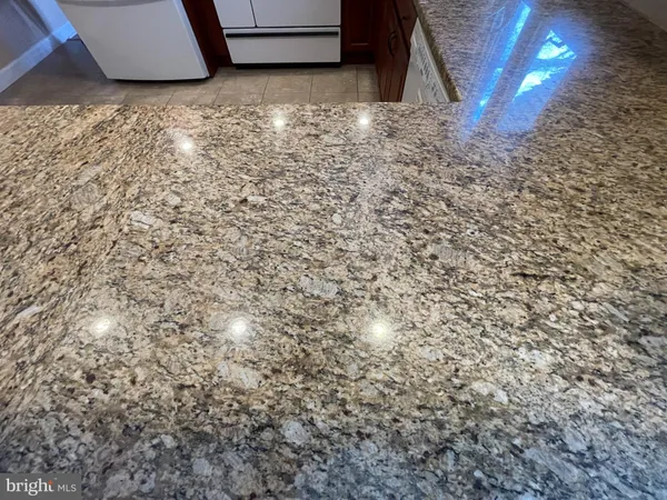 a living room with furniture a ceiling fan and a flat screen tv