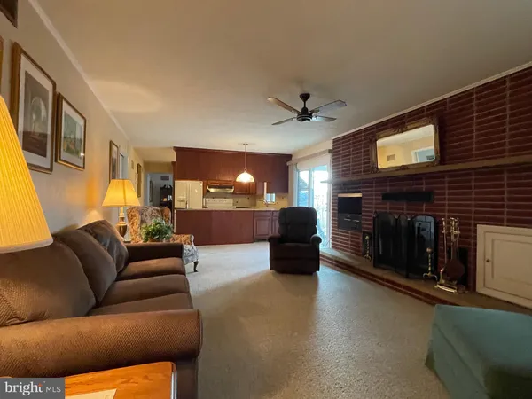 a living room with furniture and a dresser