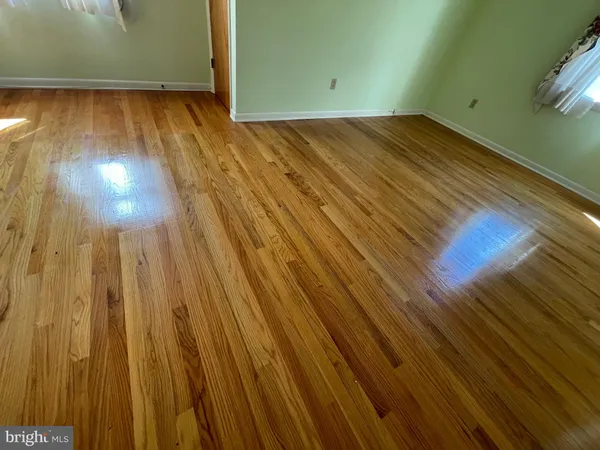 a bedroom with a large bed and a large mirror on dresser