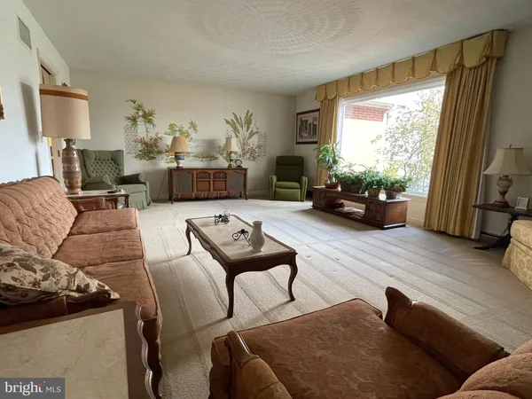 a view of a dining room with furniture and window