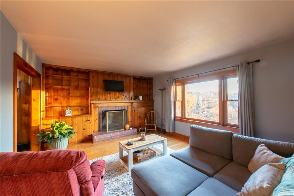 250 Rhoda Avenue Leechburg, PA 15656 - Photo 3 of 38 a living room with furniture a fireplace and a potted plants next to a window