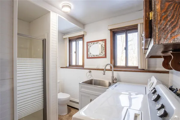 a bathroom with a sink a toilet and a window