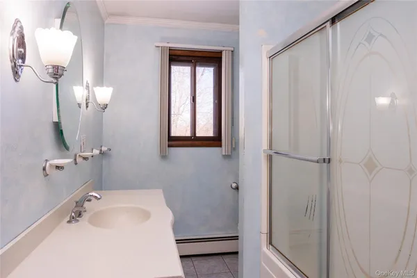 a bathroom with a sink a toilet and mirror