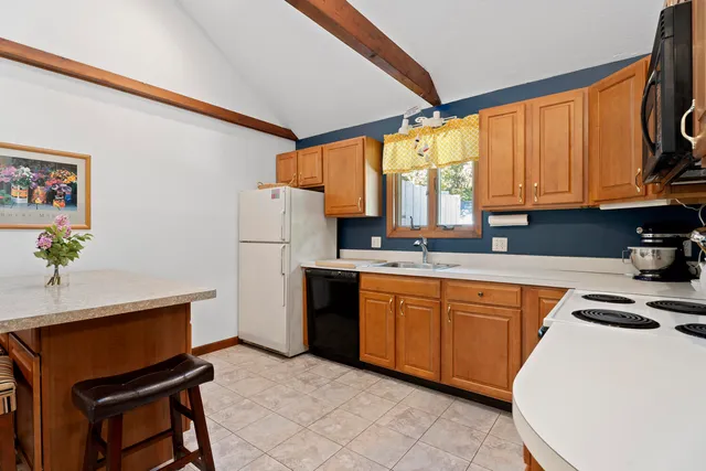 a kitchen with stainless steel appliances granite countertop a refrigerator sink and cabinets