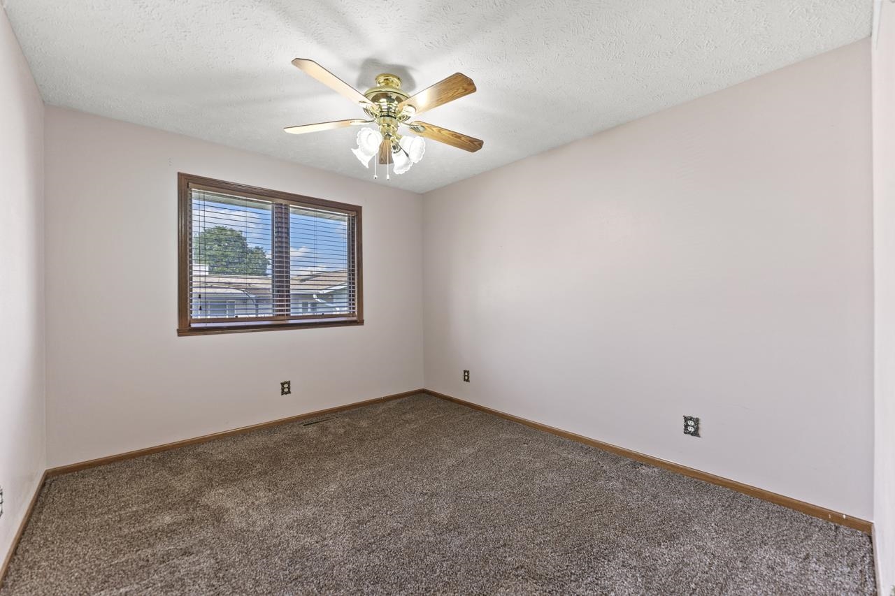1726 Baintree Road Lake Summerset, IL 61019 - Photo 20 of 39 a view of an empty room with chandelier fan and a window
