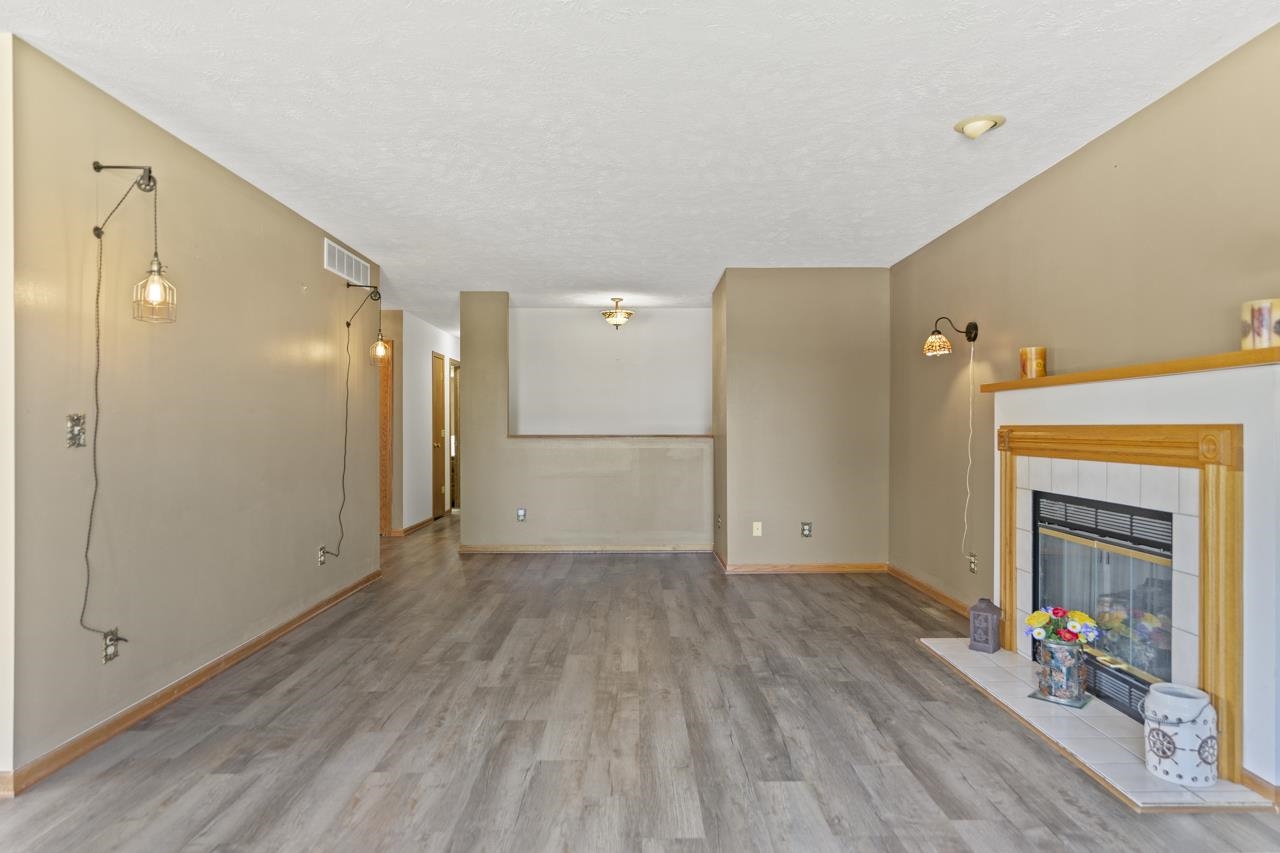 1726 Baintree Road Lake Summerset, IL 61019 - Photo 7 of 39 a view of a livingroom with wooden floor and a fireplace