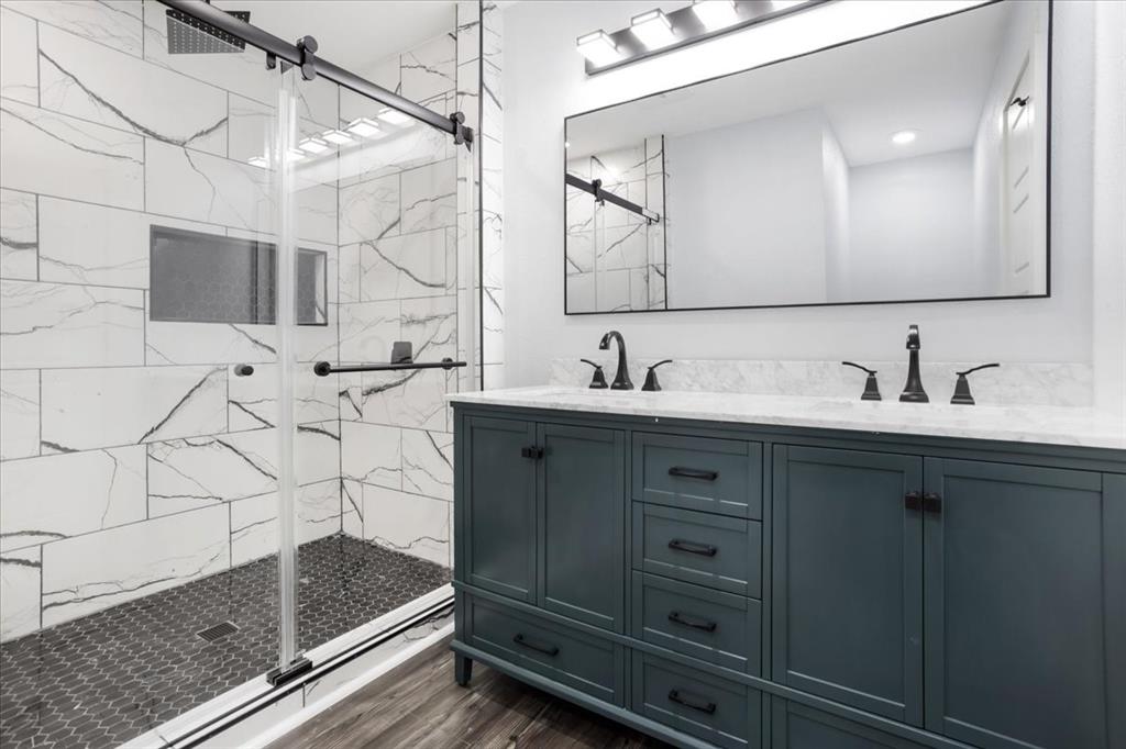 110 East Cunningham Street Bonham, TX 75418 - Photo 11 of 26 a bathroom with a sink and a mirror