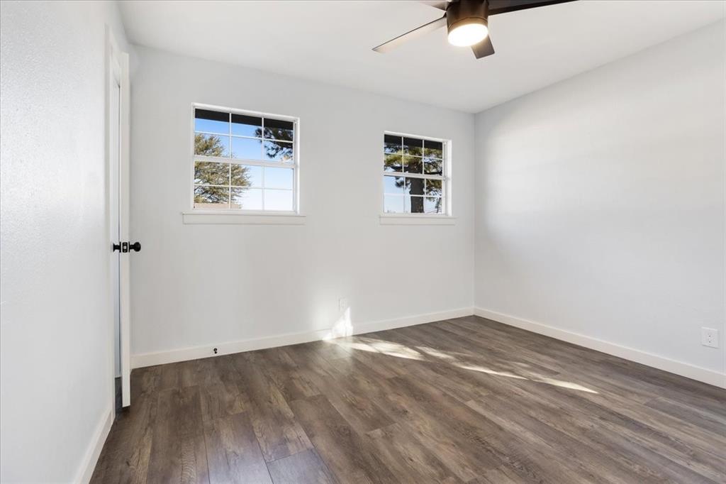 110 East Cunningham Street Bonham, TX 75418 - Photo 16 of 26 an empty room with a window and a ceiling fan