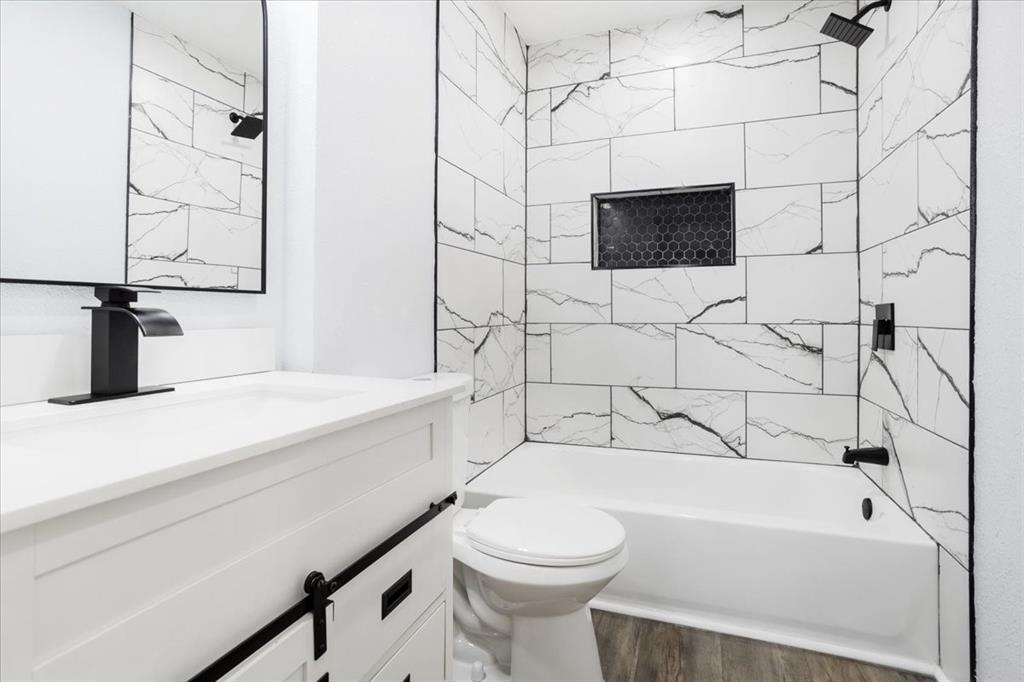 110 East Cunningham Street Bonham, TX 75418 - Photo 20 of 26 a bathroom with a sink a toilet and bathtub