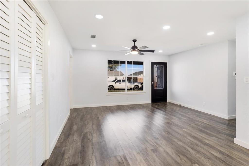 110 East Cunningham Street Bonham, TX 75418 - Photo 5 of 26 a view of an empty room with window and wooden floor