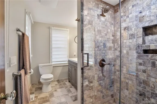 a bathroom with a toilet and a shower