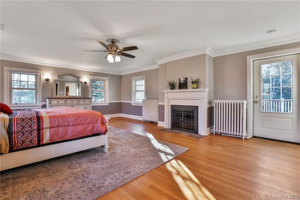 245 Townline Road West Nyack, NY 10994 - Photo 17 of 30 a spacious bedroom with a large bed and a fireplace