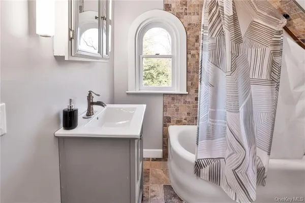 a bathroom with a sink a mirror a vanity and a window