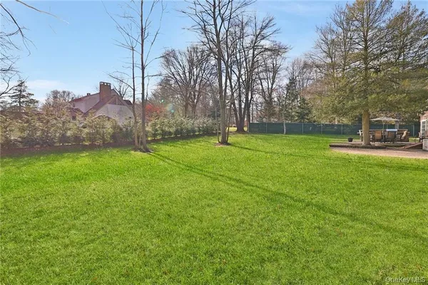 a view of a field of grass and trees