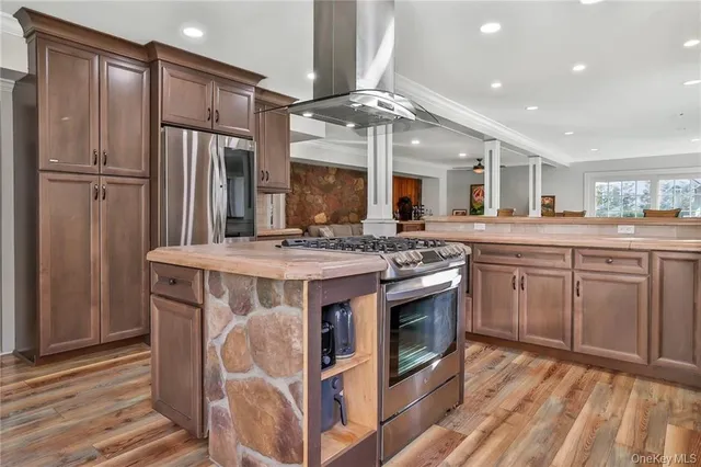 a kitchen with stainless steel appliances granite countertop a stove and a refrigerator