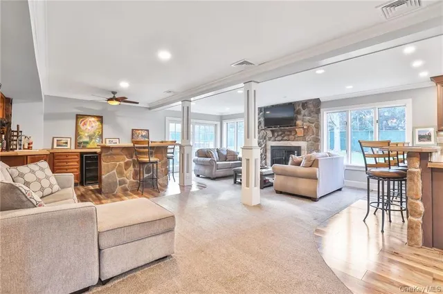 a living room with furniture and a dining table with kitchen view