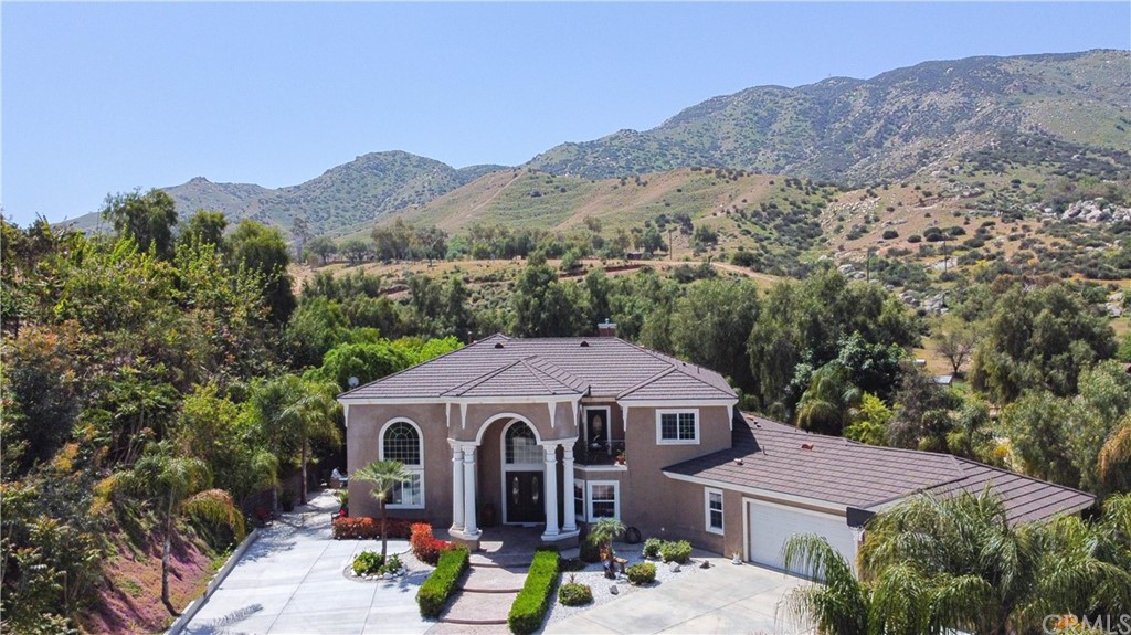 8097 Reche Canyon Road Colton, CA 92324 - Photo 1 of 1 a view of a house with a yard and a garden