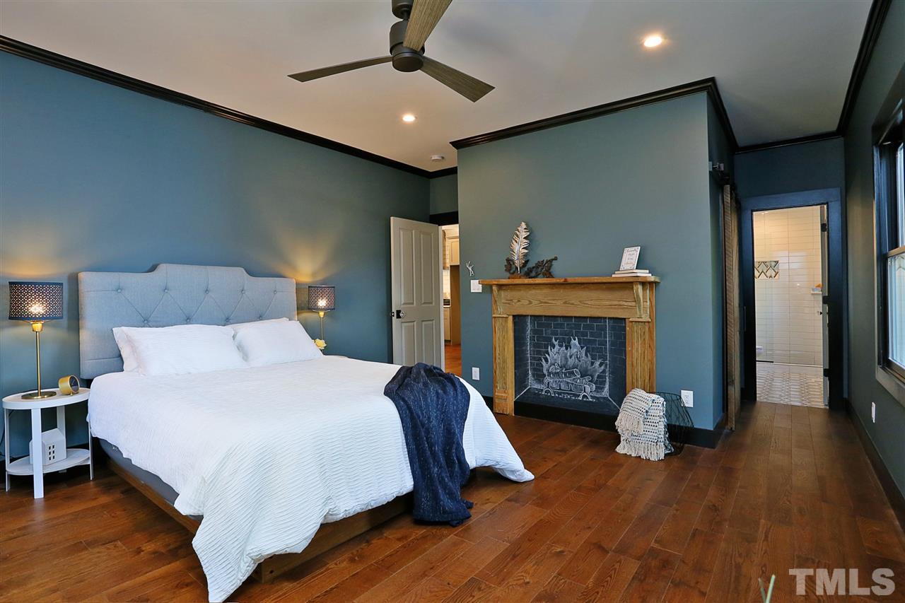 1007 South Person Street Raleigh, NC 27601 - Photo 13 of 25 Beautiful master bedroom with walk-in closet and custom bath is painted in Joanna Gaines Magnolia Home paint and has a slider to the back deck. Mantel from the original home adds more farmhouse detail.