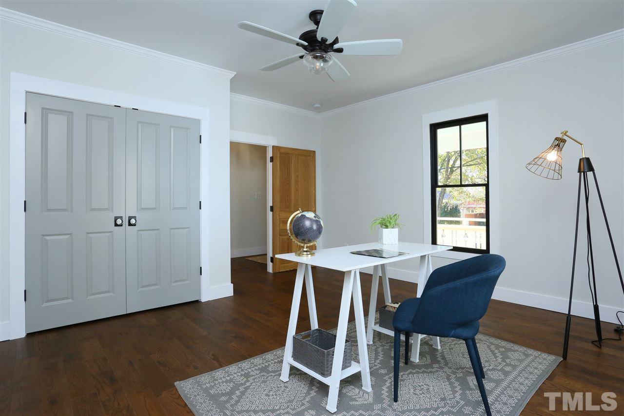 1007 South Person Street Raleigh, NC 27601 - Photo 18 of 25 One of 3 bedrooms on the main floor this large bedroom in the front of the home has an attached bath that's also accessible from the entry hall.