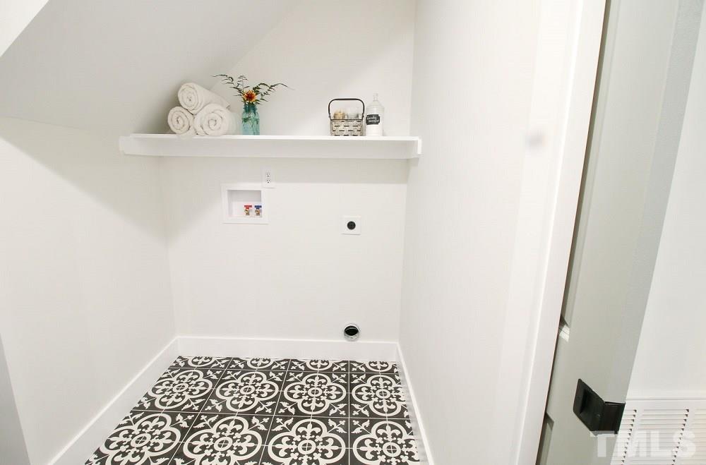 1007 South Person Street Raleigh, NC 27601 - Photo 19 of 25 Did you think you could get a laundry room this large in downtown? You'll want to stay in this laundry room with its designer cement tile floor.