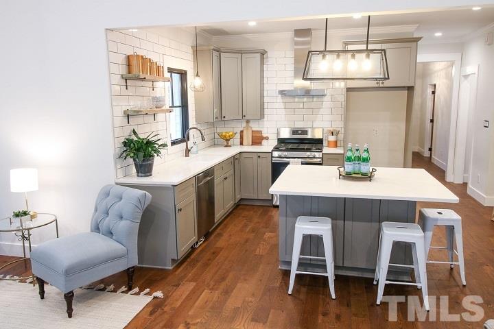 1007 South Person Street Raleigh, NC 27601 - Photo 8 of 25 Gas range, large island, great pantry with electrical to hide your microwave away. Island storage designed with 5 large drawers for easy access to your kitchen supplies. Greet guest on your side porch from the kitchen window!