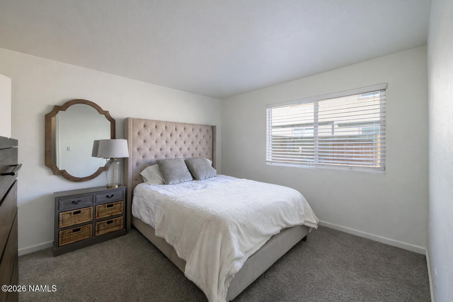 2560 East Cassidy Lane Flagstaff, AZ 86004 - Photo 16 of 31 a bed sitting in a bedroom next to a window