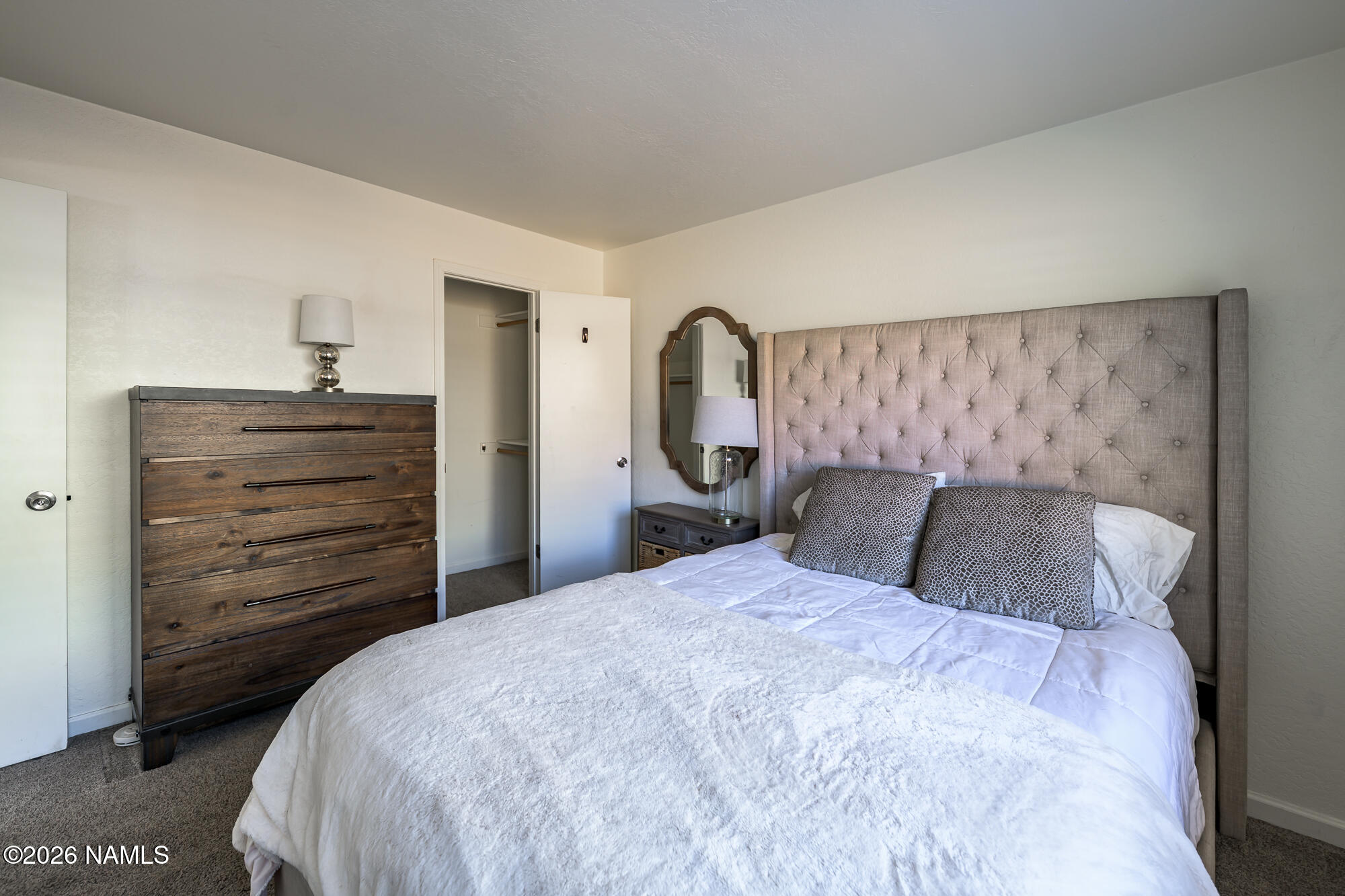 2560 East Cassidy Lane Flagstaff, AZ 86004 - Photo 17 of 31 a bedroom with a bed and a dresser