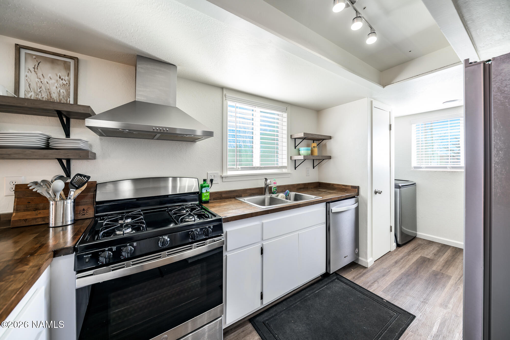 2560 East Cassidy Lane Flagstaff, AZ 86004 - Photo 4 of 31 a kitchen with stainless steel appliances a stove and a wooden floors