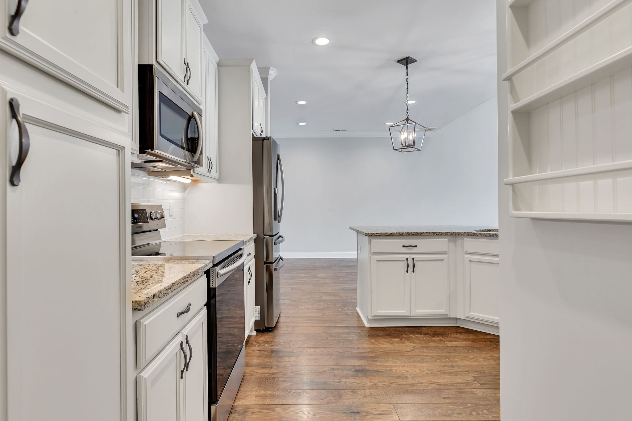 3508 Pershing Drive Murfreesboro, TN 37129 - Photo 11 of 38 a kitchen with stainless steel appliances granite countertop a refrigerator a oven and white cabinets with wooden floors
