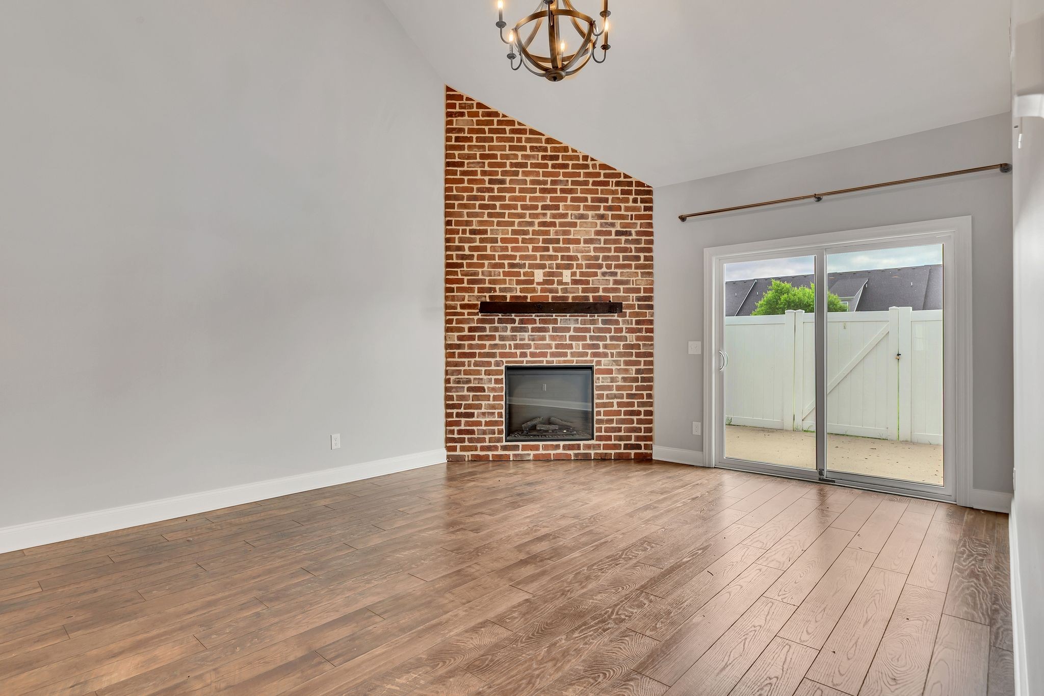 3508 Pershing Drive Murfreesboro, TN 37129 - Photo 23 of 38 a view of an empty room with wooden floor fireplace and a window