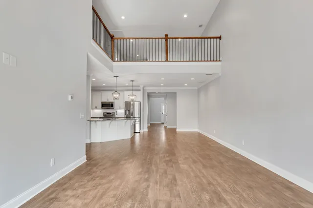 a view of empty room with wooden floor