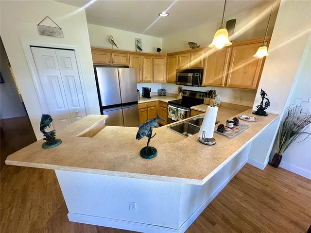 a kitchen with a sink appliances and cabinets