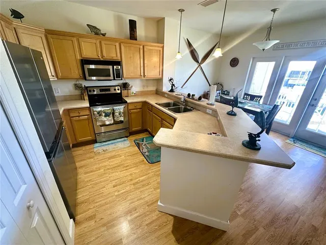 a kitchen with stainless steel appliances granite countertop a refrigerator and a stove top oven