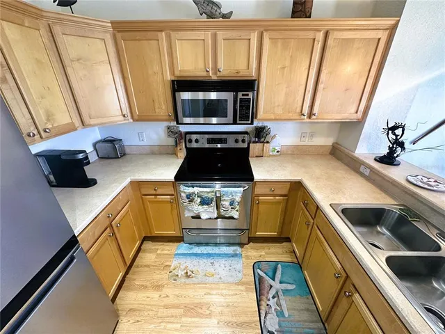 a kitchen with a refrigerator and a stove top oven