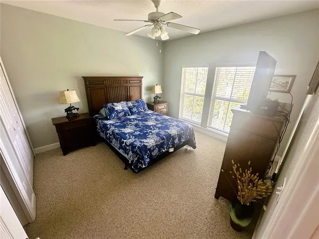 a bed sitting in a bedroom next to a window