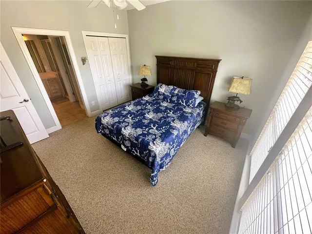 a bedroom with a bed dresser and a window