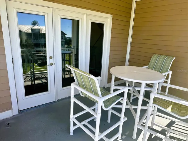 a view of a house with swimming pool and sitting area