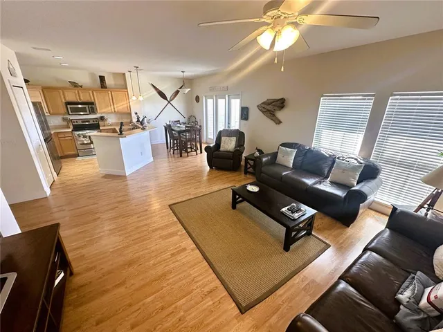a view of living room with furniture and wooden floor